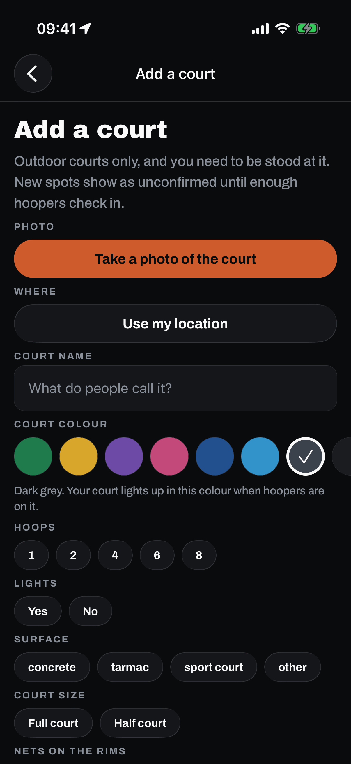The Add a court screen: outdoor courts only and you need to be stood at it, with a Take a photo of the court button, Use my location, a court name field, and questions for hoops, lights, surface, court size, nets on the rims, and free and open to the public.